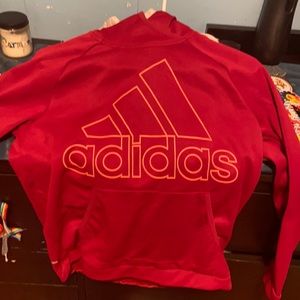 A red adidas sweater